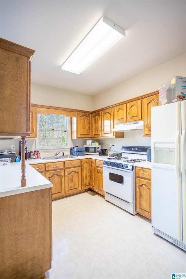 kitchen featuring white appliances and sink