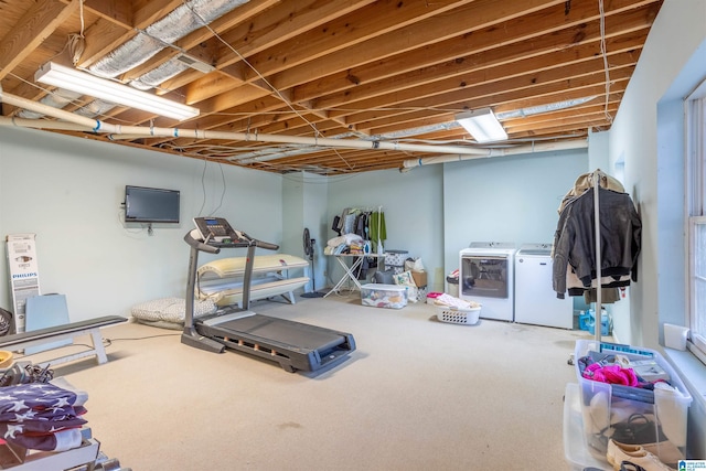 exercise room with carpet and independent washer and dryer