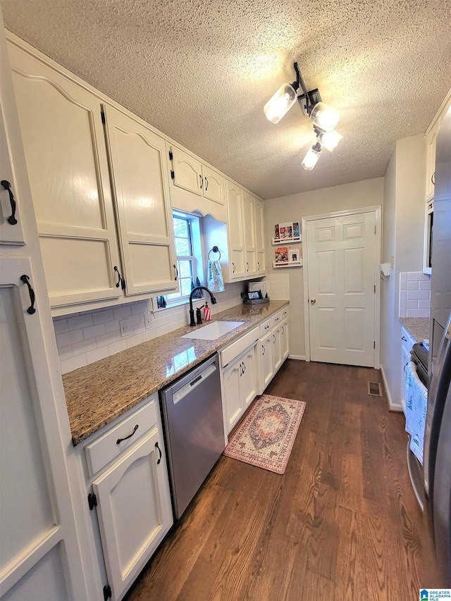 kitchen featuring tasteful backsplash, white cabinetry, dishwasher, and stone countertops