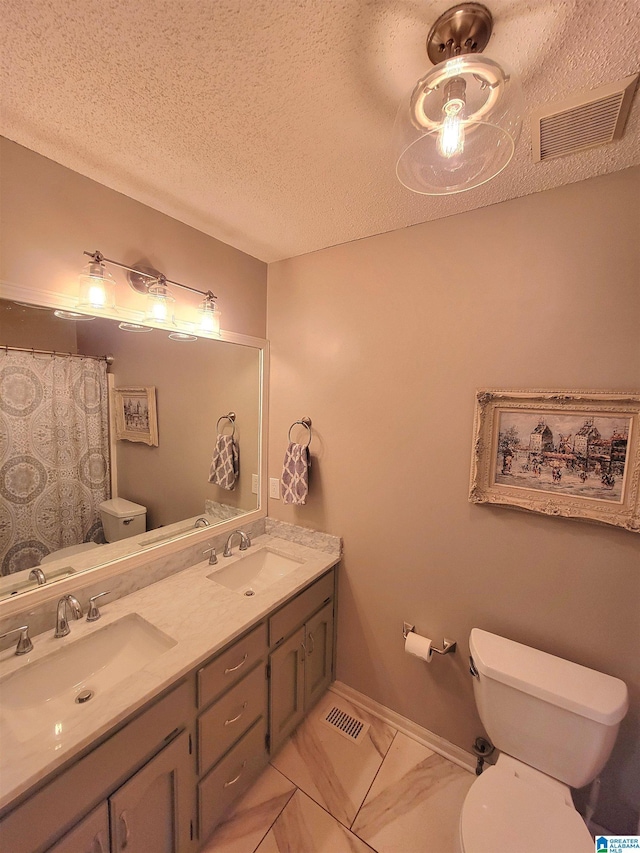 bathroom with vanity, a textured ceiling, toilet, and walk in shower