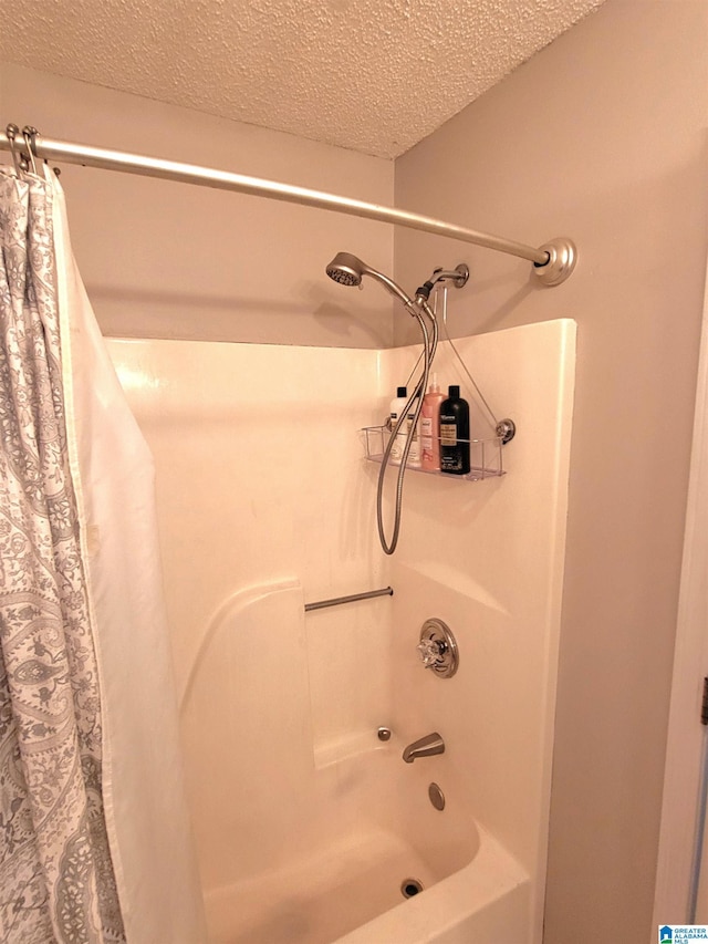 bathroom featuring shower / tub combo and a textured ceiling