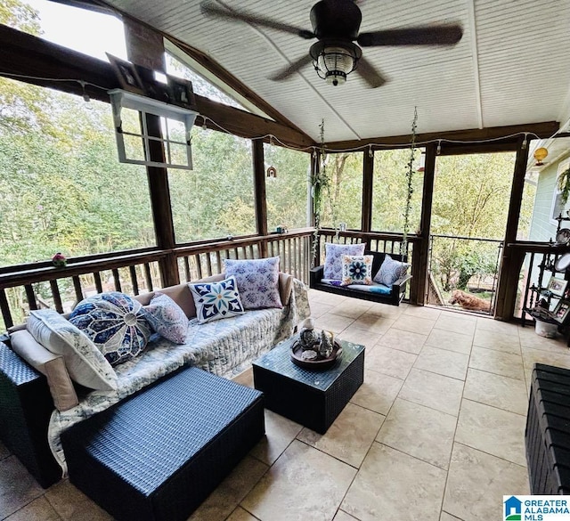 sunroom featuring ceiling fan and vaulted ceiling