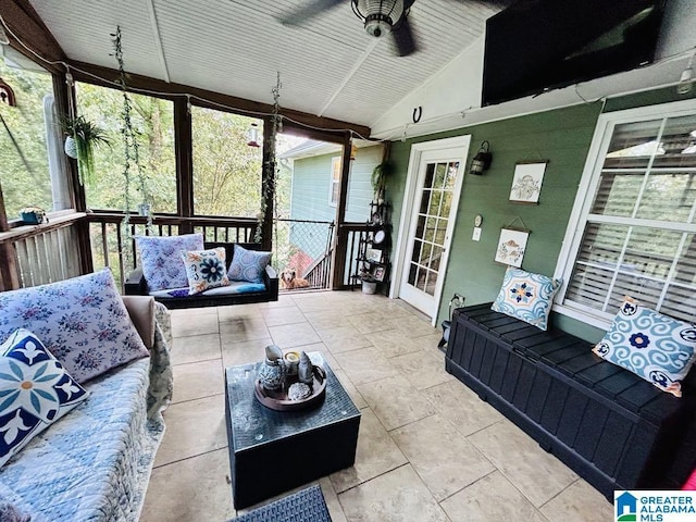 sunroom featuring ceiling fan and vaulted ceiling