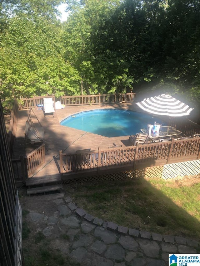 view of swimming pool featuring a wooden deck