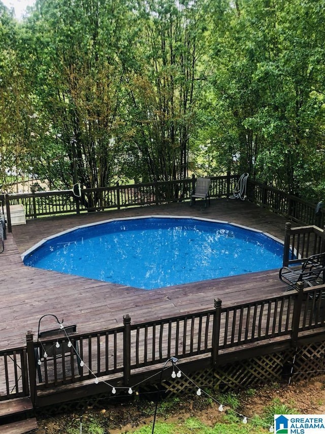 view of swimming pool featuring a deck