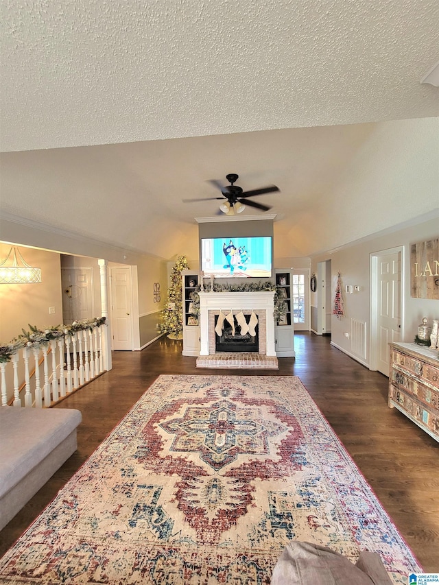 living room featuring a textured ceiling, ceiling fan, dark hardwood / wood-style flooring, and lofted ceiling