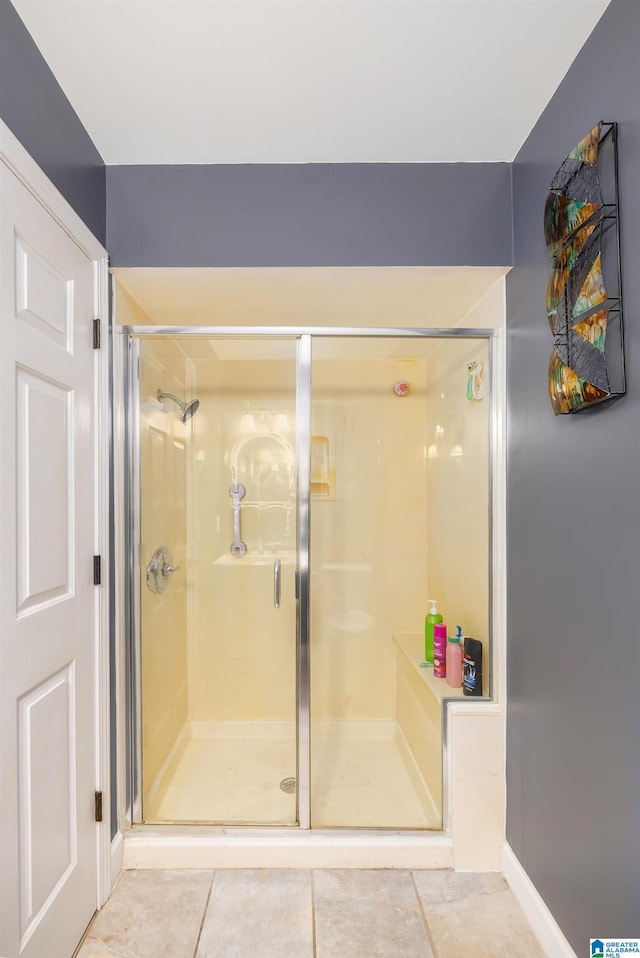 bathroom with tile patterned floors and an enclosed shower