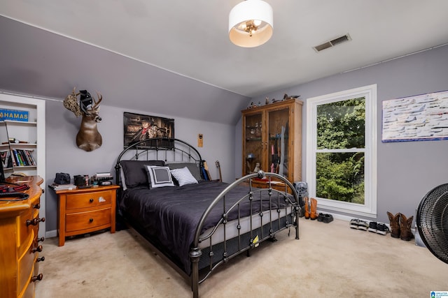 bedroom with vaulted ceiling, light carpet, and multiple windows