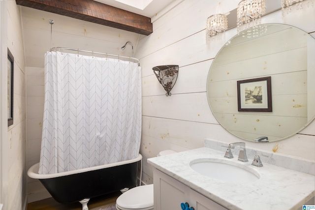 full bathroom with beamed ceiling, vanity, toilet, and wooden walls