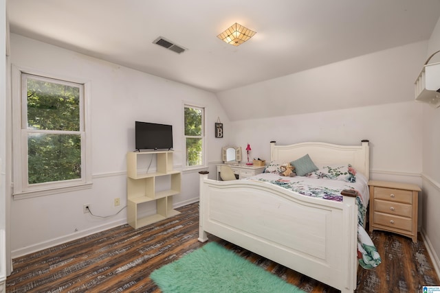 bedroom with dark hardwood / wood-style flooring and lofted ceiling