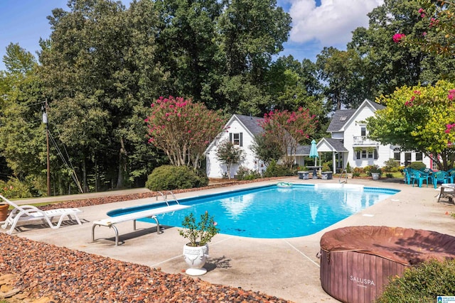 view of pool featuring a diving board and a patio area