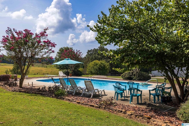 view of swimming pool featuring a diving board, a patio area, and a yard