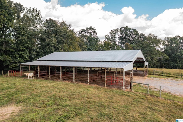 view of horse barn featuring a rural view