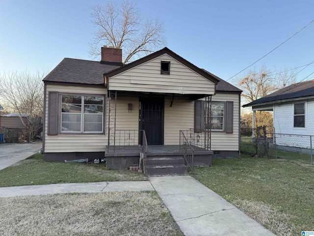 bungalow-style house with a front yard