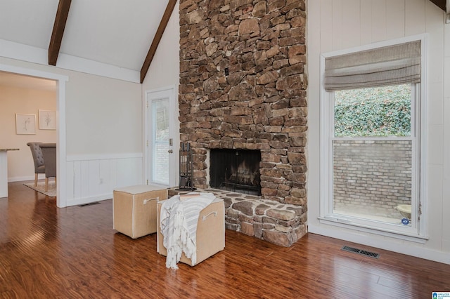 unfurnished living room featuring beam ceiling, dark hardwood / wood-style flooring, a fireplace, and high vaulted ceiling