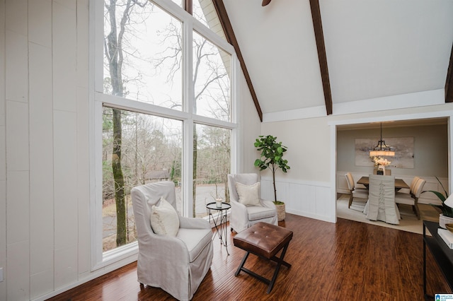 living area featuring beam ceiling, high vaulted ceiling, and hardwood / wood-style flooring