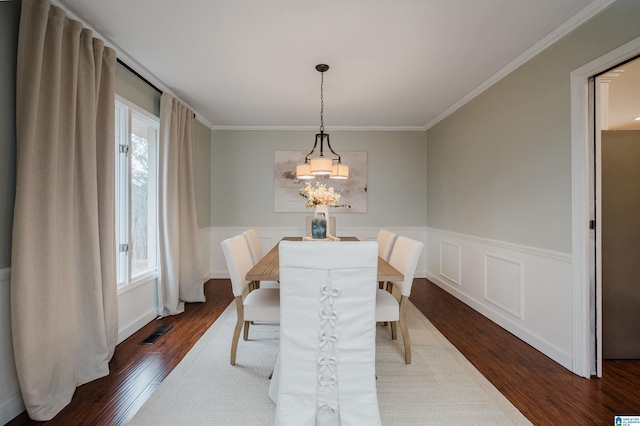 dining room featuring a wealth of natural light, dark wood-type flooring, and ornamental molding