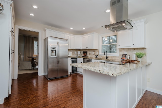 kitchen with white cabinetry, dark hardwood / wood-style flooring, kitchen peninsula, island exhaust hood, and appliances with stainless steel finishes