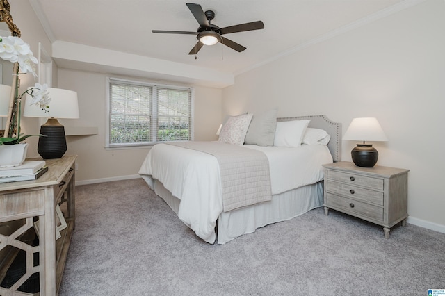 carpeted bedroom featuring ceiling fan and ornamental molding