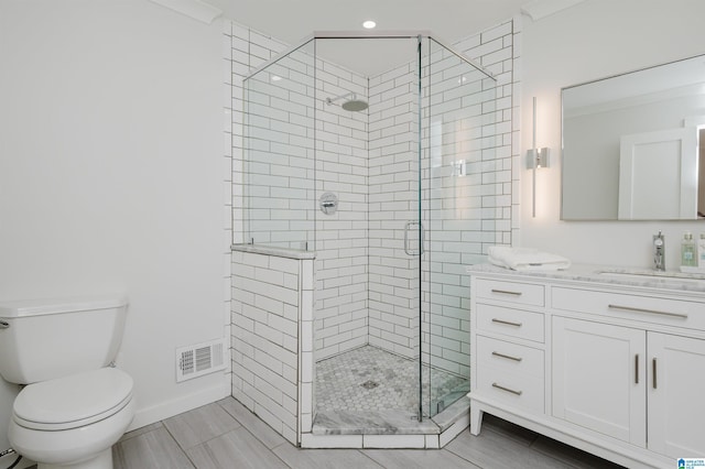 bathroom featuring vanity, toilet, and walk in shower