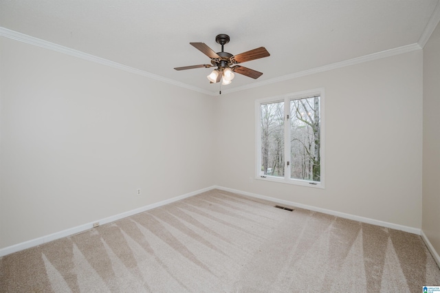 unfurnished room featuring carpet, ceiling fan, and ornamental molding