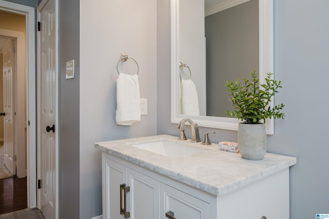 bathroom featuring crown molding and vanity