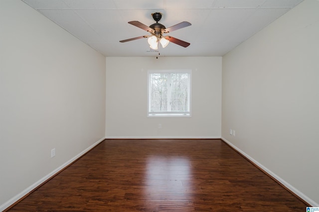 spare room featuring dark hardwood / wood-style flooring and ceiling fan