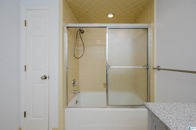 bathroom featuring bath / shower combo with glass door