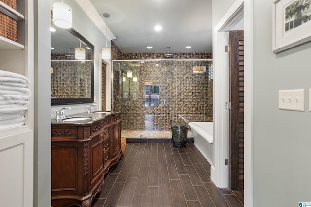 bathroom featuring vanity and independent shower and bath