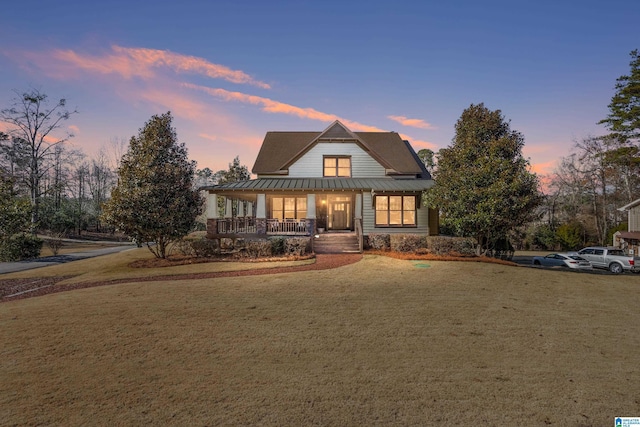 view of front facade featuring a lawn and a porch