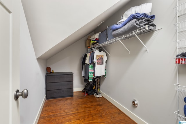 spacious closet featuring dark wood-type flooring and lofted ceiling