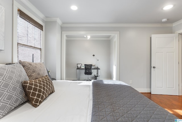 bedroom with crown molding and dark wood-type flooring