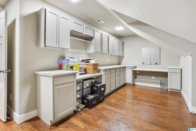 kitchen with dark wood-type flooring and vaulted ceiling