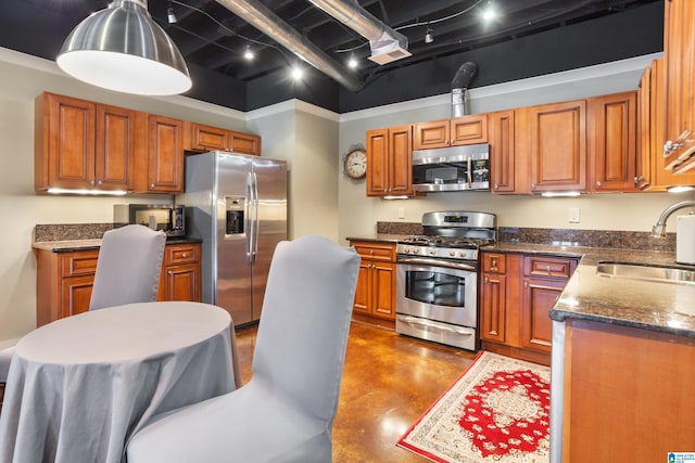 kitchen with a high ceiling, sink, dark stone countertops, concrete floors, and stainless steel appliances