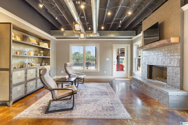 living area featuring built in shelves and a fireplace