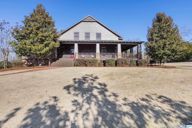 view of front of property featuring covered porch and a front yard