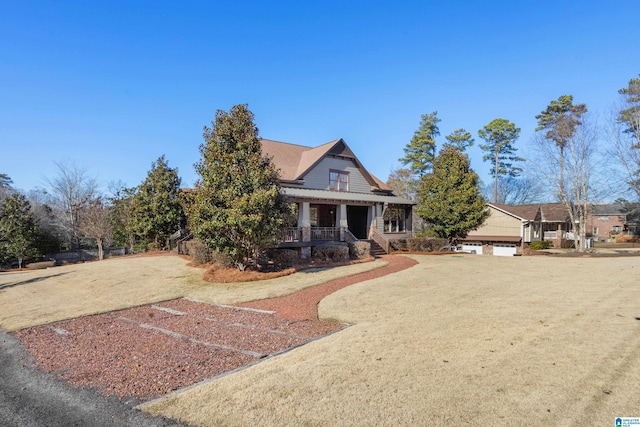 craftsman-style house featuring covered porch and a garage