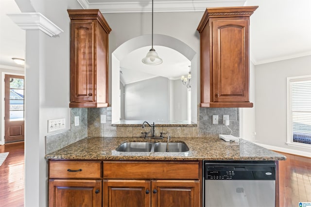 kitchen with tasteful backsplash, stainless steel dishwasher, dark stone counters, ornamental molding, and sink