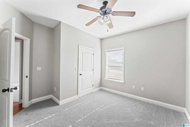 unfurnished bedroom with ceiling fan, a closet, and light carpet