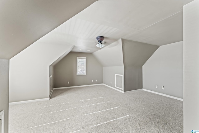 additional living space featuring ceiling fan, light carpet, and vaulted ceiling