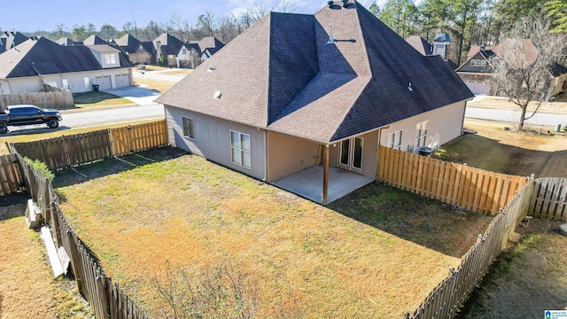 rear view of property featuring a yard and a patio