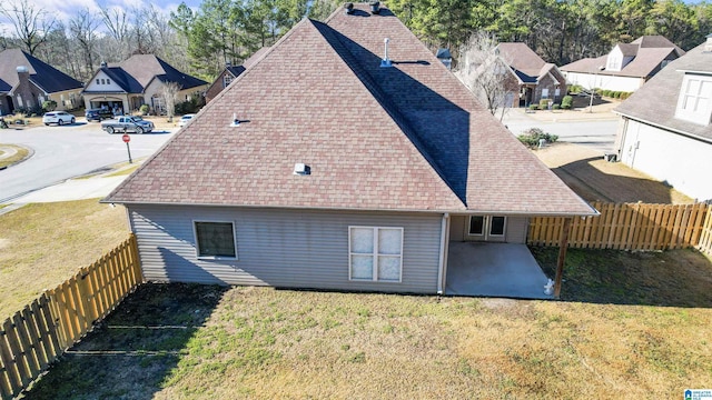 rear view of property with a patio area and a lawn