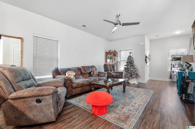 living room featuring a wealth of natural light, ceiling fan, and dark hardwood / wood-style floors