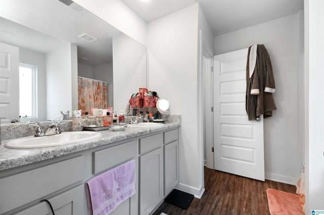 bathroom with vanity and hardwood / wood-style flooring