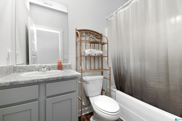 full bathroom with vanity, toilet, and shower / bath combo with shower curtain