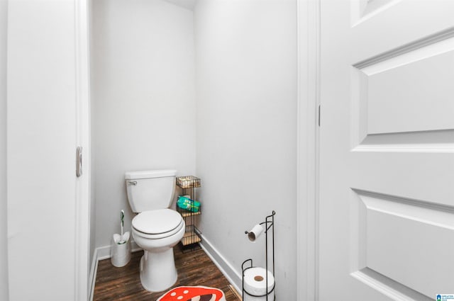 bathroom with hardwood / wood-style flooring and toilet