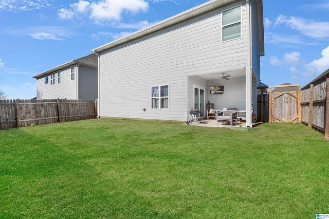 rear view of property with outdoor lounge area, ceiling fan, a patio area, and a yard