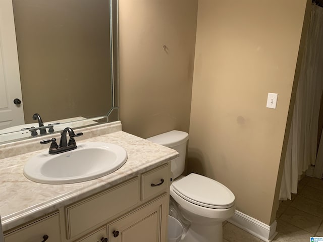 bathroom with toilet, tile patterned floors, and vanity