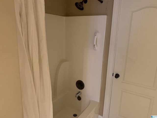 bathroom with shower / bath combination with curtain