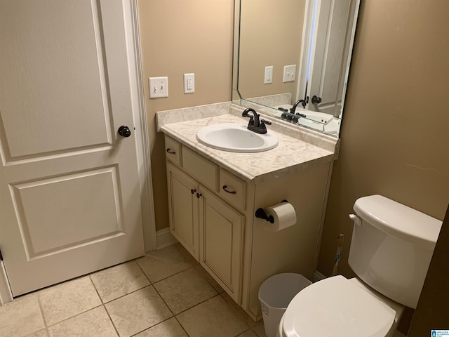 bathroom with tile patterned floors, vanity, and toilet